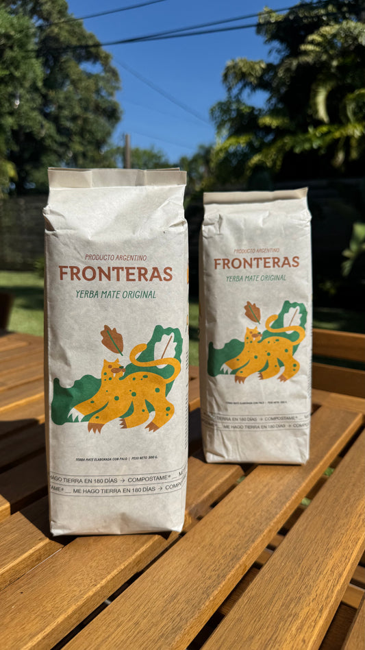 Two Fronteras yerba mate packages on a wooden table with a natural background